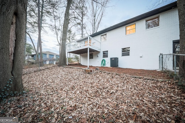 rear view of house featuring a balcony and central air condition unit