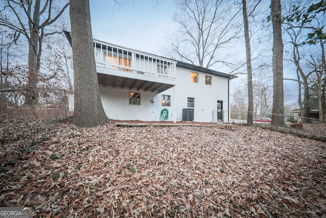 rear view of property with central AC and a wooden deck