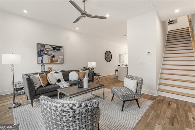 living room with hardwood / wood-style flooring and ceiling fan