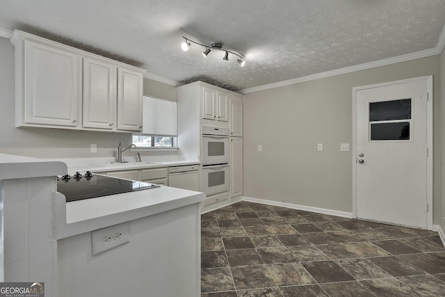 kitchen featuring a textured ceiling, white cabinetry, sink, and white appliances