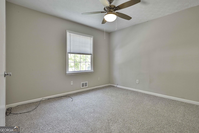 spare room featuring carpet flooring, a textured ceiling, and ceiling fan