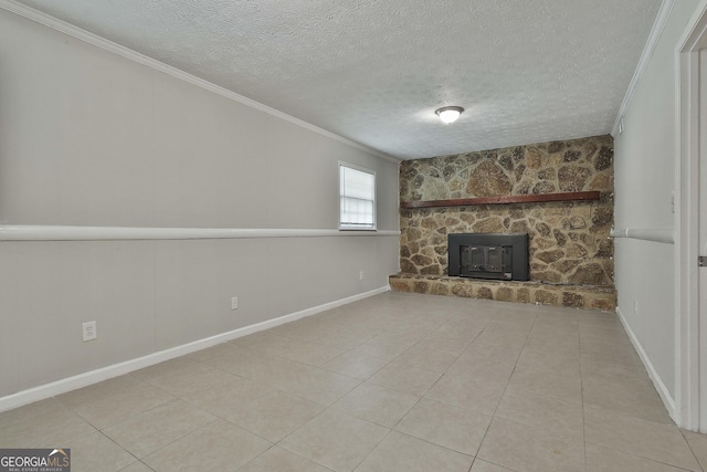 unfurnished living room featuring a wood stove, crown molding, light tile patterned floors, and a textured ceiling