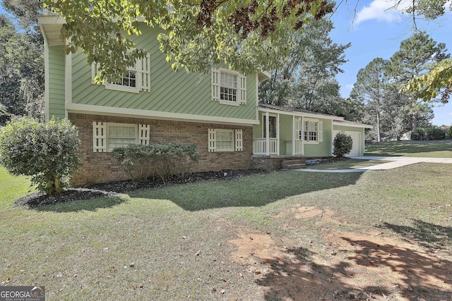 tri-level home with a garage and a front lawn