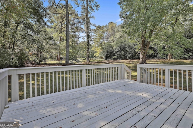 wooden deck featuring a yard