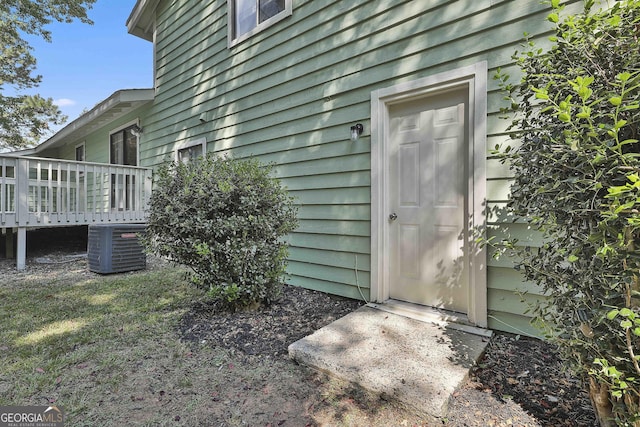 doorway to property featuring a deck and central air condition unit