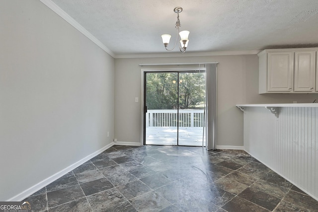 unfurnished dining area featuring crown molding, a chandelier, and a textured ceiling