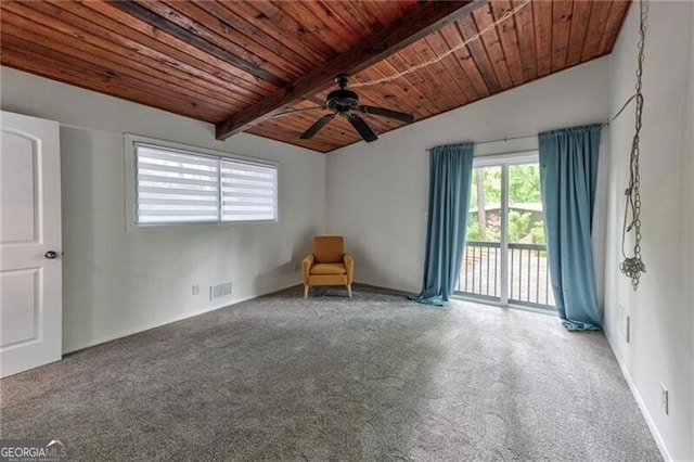 carpeted empty room featuring beam ceiling, ceiling fan, and wood ceiling