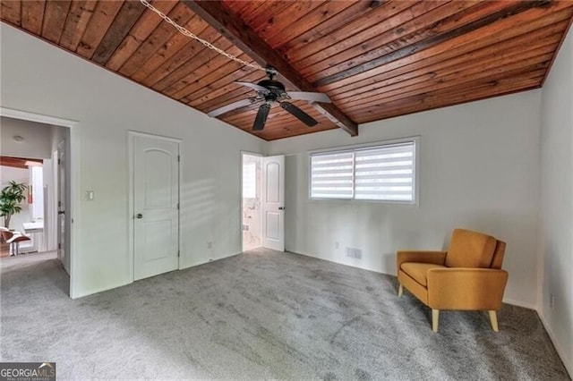 unfurnished room featuring vaulted ceiling with beams, carpet floors, ceiling fan, and wooden ceiling