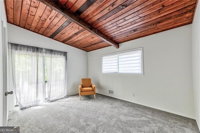 unfurnished room with carpet, vaulted ceiling with beams, and wood ceiling