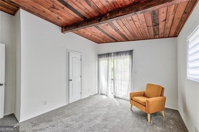 unfurnished room with beam ceiling, carpet, and wood ceiling