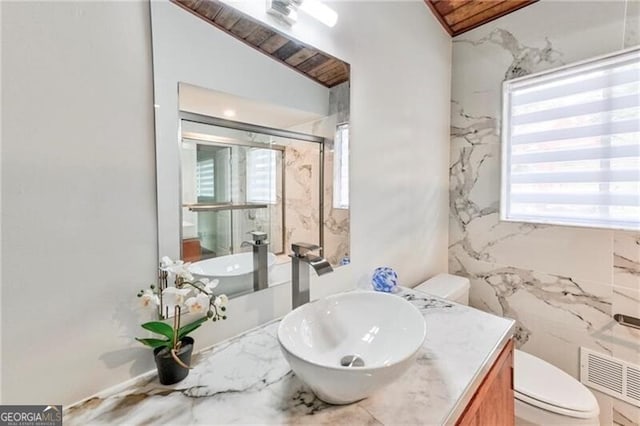 bathroom with vanity, toilet, and lofted ceiling