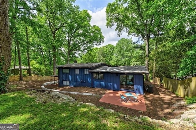 view of outbuilding featuring central AC unit and a yard