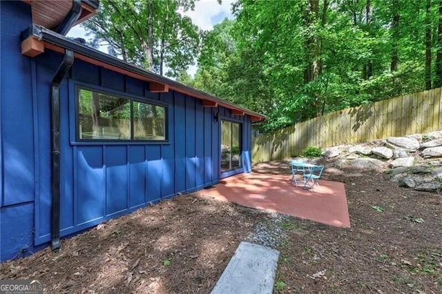 view of side of property featuring a patio area