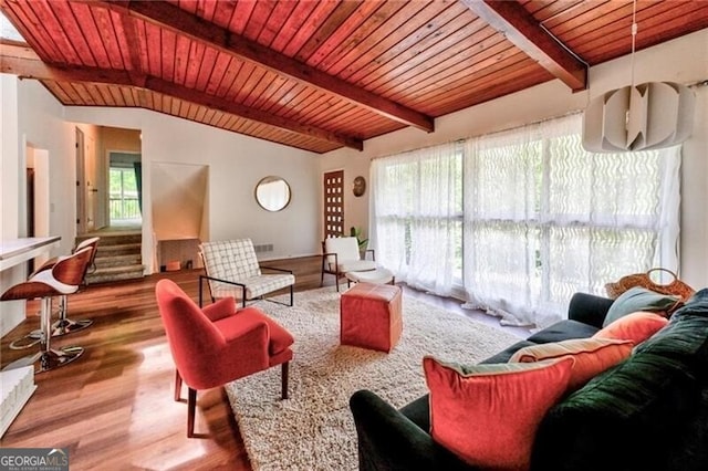 living room with wood-type flooring, vaulted ceiling with beams, and wooden ceiling