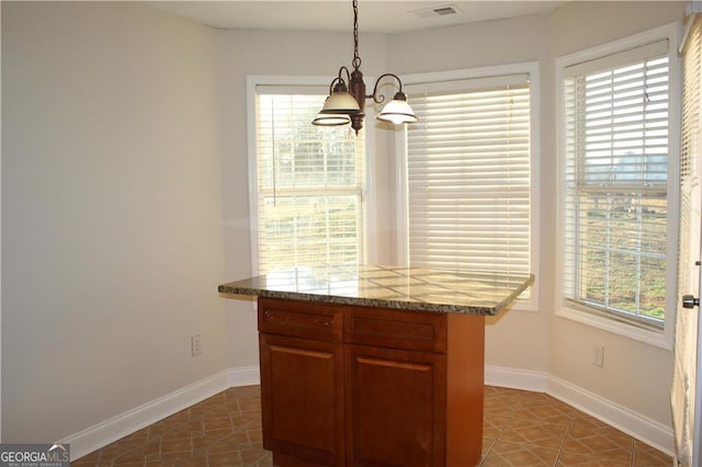 kitchen featuring pendant lighting, tile patterned floors, and a wealth of natural light