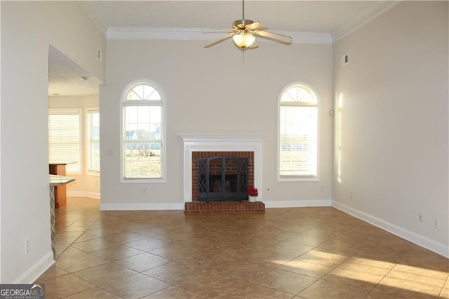 unfurnished living room with a brick fireplace, light tile patterned flooring, crown molding, and ceiling fan