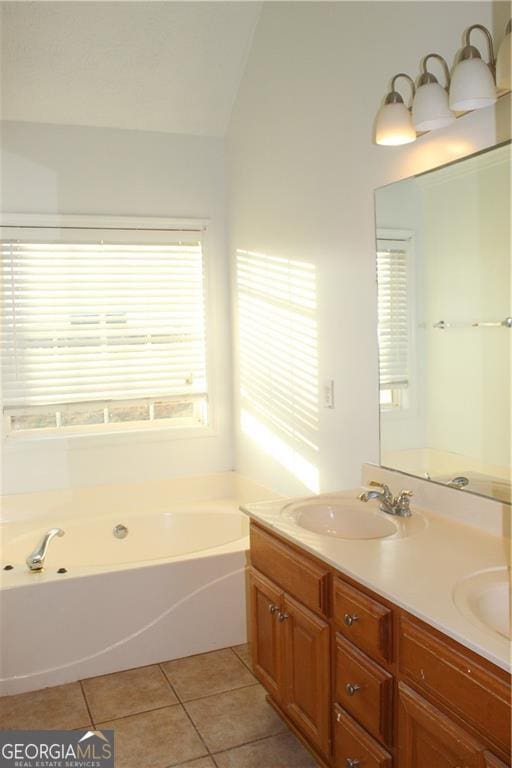 bathroom with vaulted ceiling, a bathing tub, tile patterned floors, and vanity