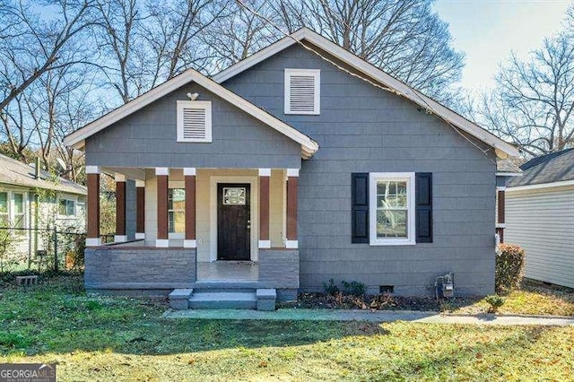 view of front of home featuring covered porch and a front yard