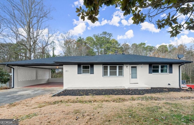 ranch-style house featuring a carport