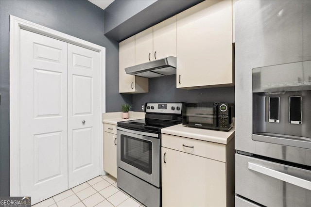 kitchen with light tile patterned floors and stainless steel appliances