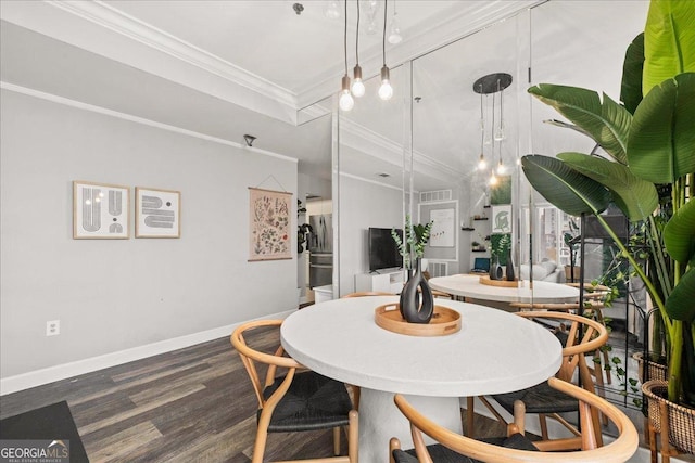 dining space with dark hardwood / wood-style floors and ornamental molding