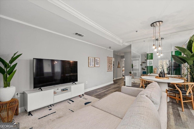 living room featuring dark hardwood / wood-style flooring and crown molding