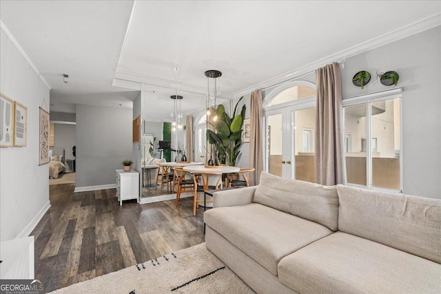 living room with crown molding, french doors, and dark hardwood / wood-style floors