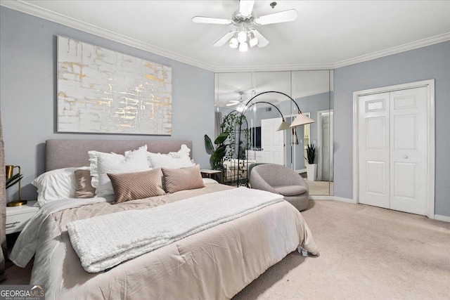 carpeted bedroom with a closet, ceiling fan, and crown molding