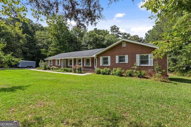 single story home with covered porch and a front yard