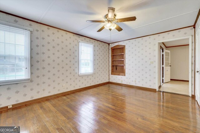 711 Stone Ave, Waynesboro, GA 30830 - spare room with hardwood / wood-style floors, plenty of natural light, ceiling fan, and ornamental molding
