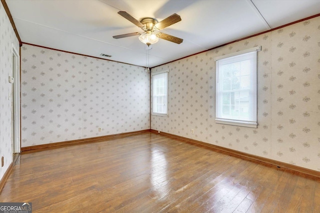 711 Stone Ave, Waynesboro, GA 30830 - spare room featuring hardwood / wood-style flooring, ceiling fan, and ornamental molding