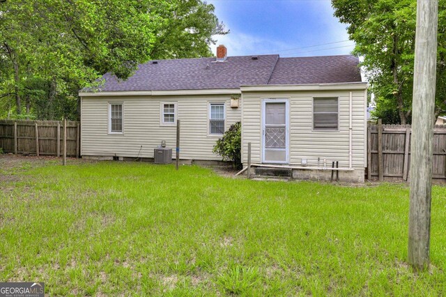 711 Stone Ave, Waynesboro, GA 30830 - back of house with a yard and central AC unit