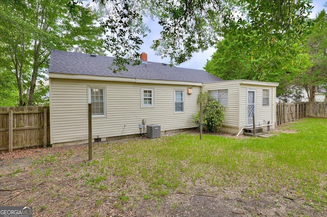 711 Stone Ave, Waynesboro, GA 30830 - back of house featuring a lawn and central AC