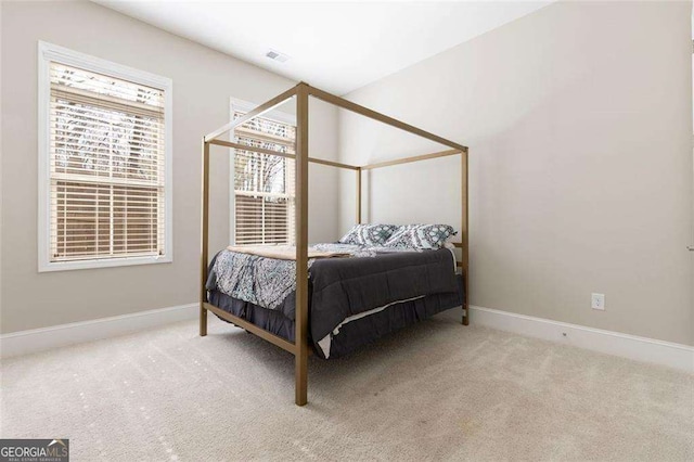 bedroom featuring light carpet