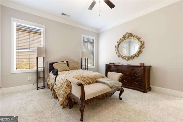 carpeted bedroom with ceiling fan and crown molding