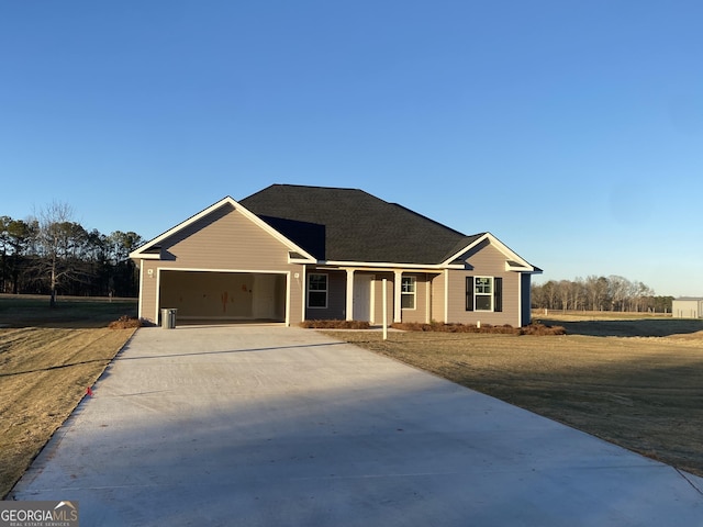 single story home featuring a front lawn and a garage