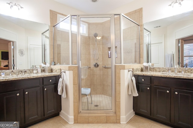 bathroom featuring tile patterned flooring, vanity, and an enclosed shower