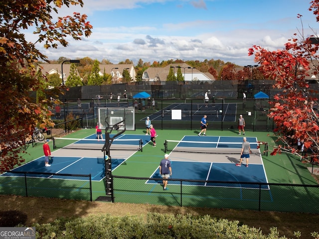 view of tennis court featuring fence