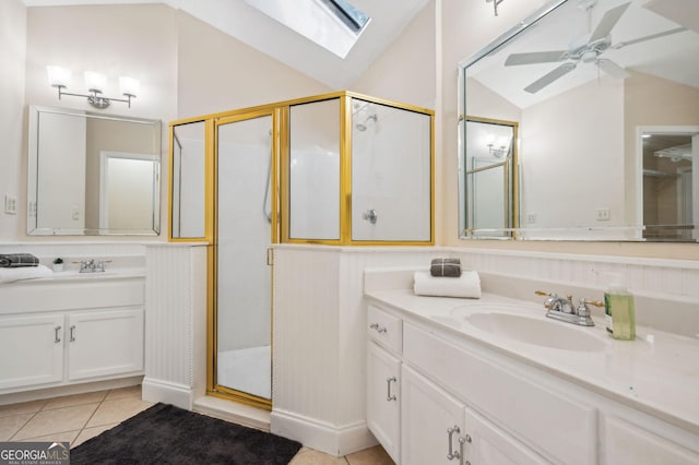 bathroom featuring vanity, lofted ceiling with skylight, tile patterned flooring, ceiling fan, and an enclosed shower