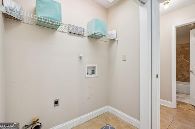 washroom with tile patterned flooring, hookup for a washing machine, and electric dryer hookup