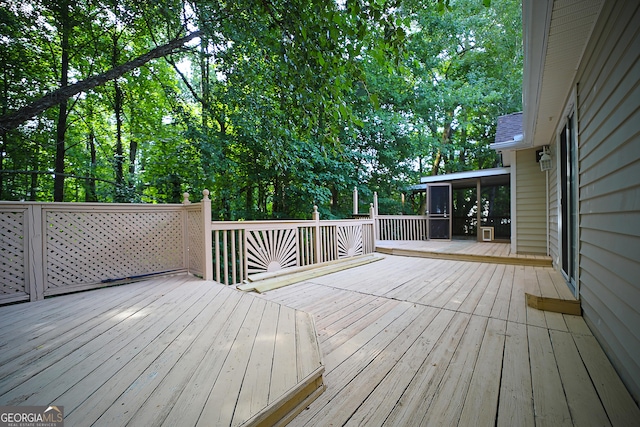 wooden deck with a sunroom