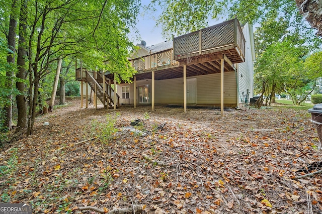 back of house with a wooden deck