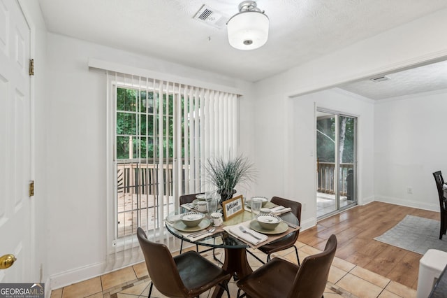 tiled dining room featuring a textured ceiling