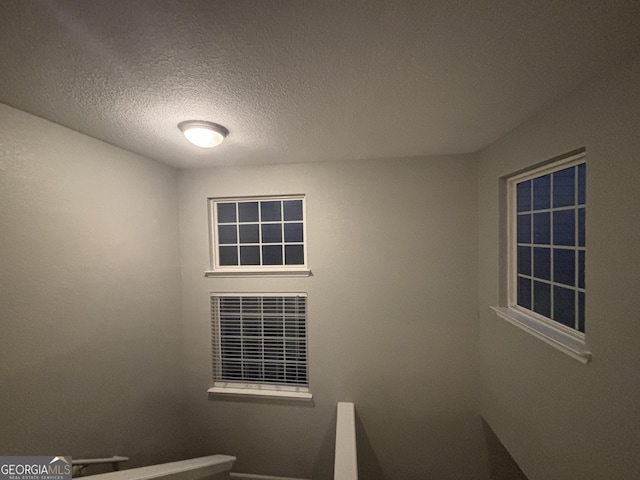 staircase with a textured ceiling