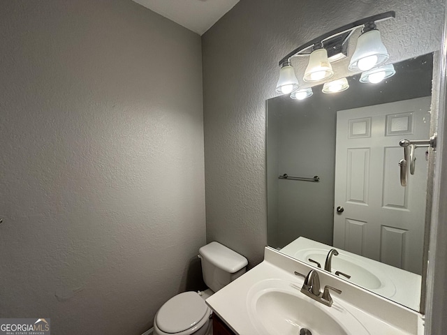 bathroom featuring toilet and vanity