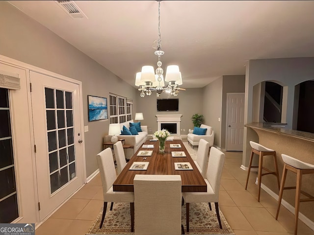 dining space featuring a chandelier and light tile patterned floors