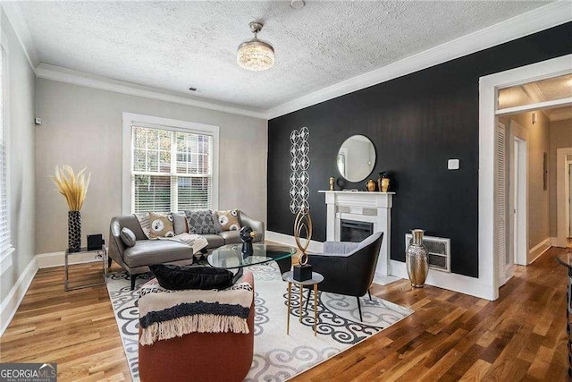 living room with a textured ceiling, hardwood / wood-style flooring, and crown molding