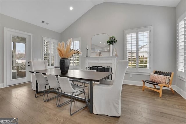 dining area featuring vaulted ceiling and hardwood / wood-style floors