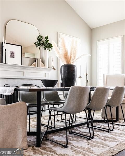 dining space featuring vaulted ceiling