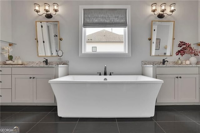 bathroom with vanity, tile patterned floors, and a bathing tub